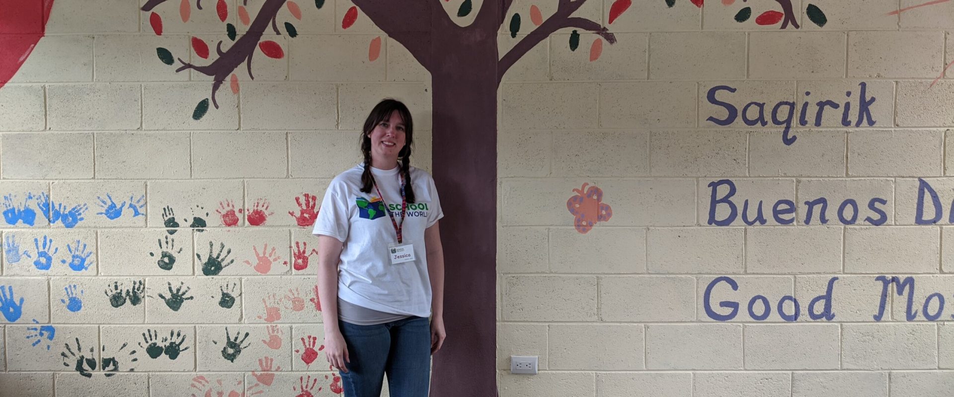 Jessica Ennis poses in front of her classroom mural in Guatemala